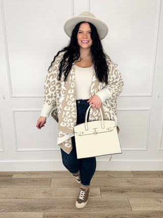 Oat and cream leopard print oversized cardigan styled over an ivory tank with dark wash skinny jeans and brown sneakers.