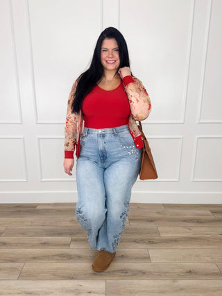 Sheer mesh cardigan with a vintage floral print and rust ribbing worn over a red tank with embroidered wide leg jeans.