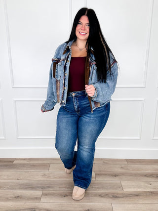 Patchwork medium wash denim jacket layered over a wine cami with dark wash straight leg jeans.