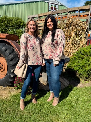 Oat knit sweater with pink and plum floral embroidery worn with dark wash skinny jeans and taupe booties at a pumpkin patch.