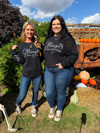 Long-sleeve black graphic tee and blue jeans outfit