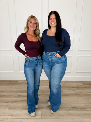 Wine and navy square neck long sleeve tops paired with Risen Mira flare jeans and cream booties.