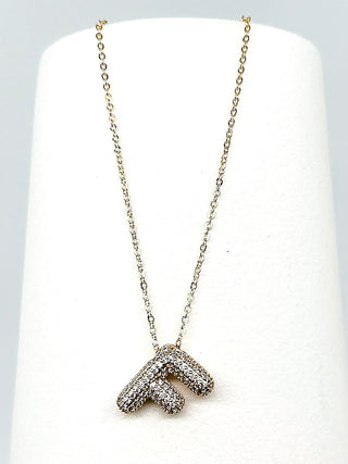 Gold initial necklace with a sparkling rhinestone letter pendant on a fine chain