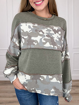 Green long sleeve top with camo yoke panel and raglan sleeves, round neckline.