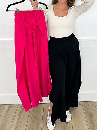 Wide-leg palazzo pants in bright pink and solid black, gathered high waist tie.
