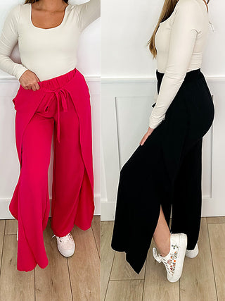 High-rise wide-leg palazzo pants, pink and black, drawstring waist with bow.