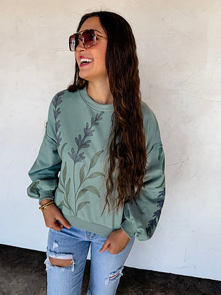 Green cotton blend pullover top with long sleeves and leaf print