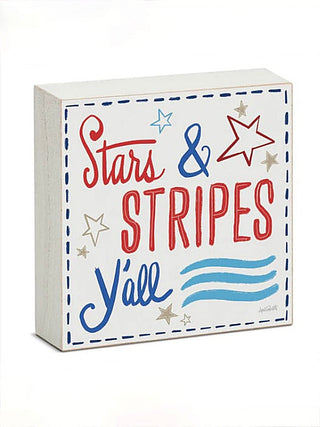 Wood block sign reading Stars & Stripes Y'all with stars and wavy line accents