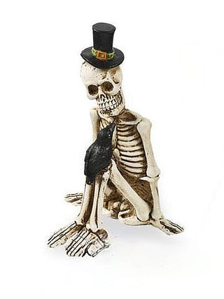 Resin skeleton decor figurine with black top hat and dark cape, kneeling pose