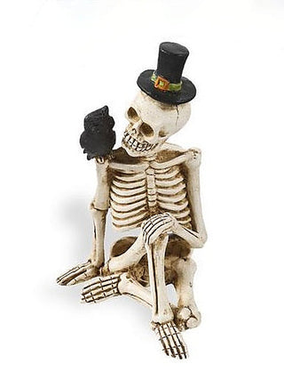 Resin skeleton decor figurine with black top hat and dark cape, crouching pose