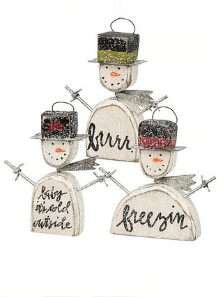Three wooden snowman ornaments with 'brrr', 'freezin', and 'stay inside' sayings
