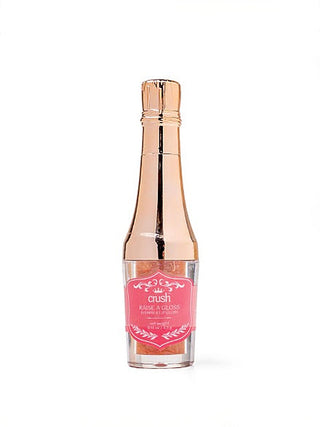 Single glossy lip gloss bottle in clear glass with rose-gold cap and pink label