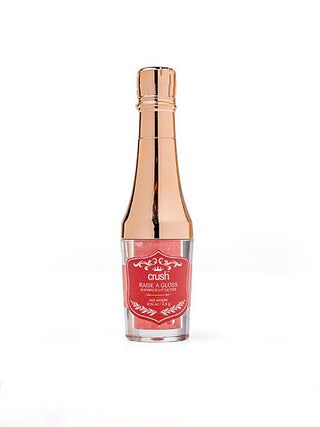 Single glossy lip gloss bottle in clear glass with rose-gold cap and red label