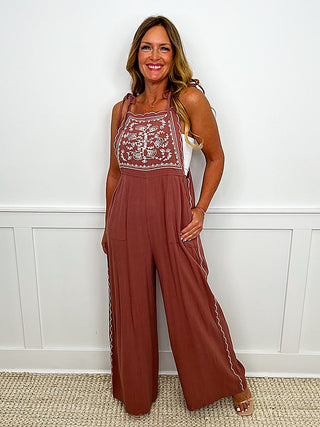 Pink sleeveless jumpsuit with embroidered trim and wide-leg pants