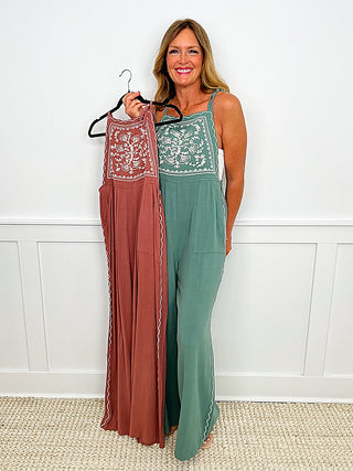Pink and green sleeveless jumpsuit with embroidered trim and wide-leg pants