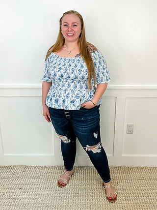 Women's blue floral short-sleeve peplum blouse with gathered waist