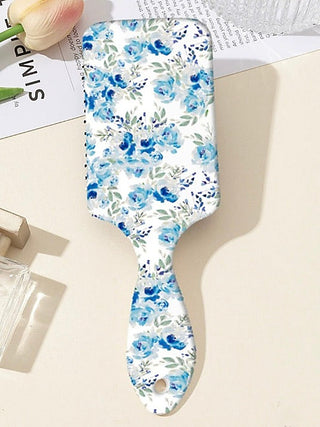 Blue floral detangling hair brush with print on a white paddle handle