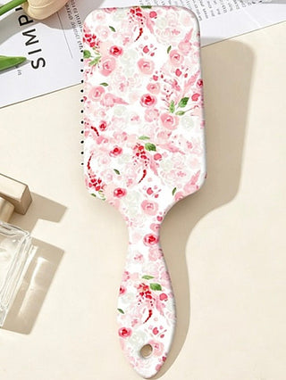 Pink rose floral detangling hair brush with print on a white paddle handle