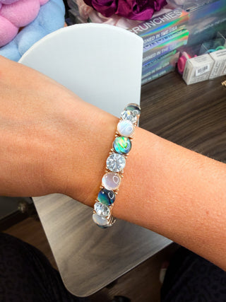 CZ charm bracelet with green, blue, and champagne stones