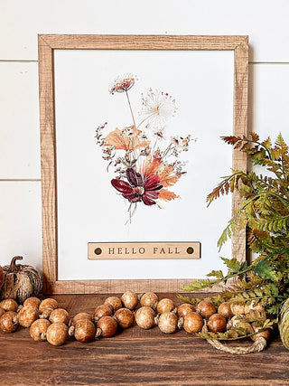 Light wood framed wall sign with floral dandelion art and "HELLO FALL" metal plate