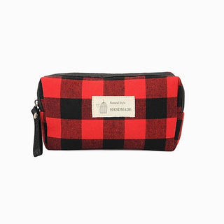 Red and black buffalo plaid zippered pouch with wrist strap and front label