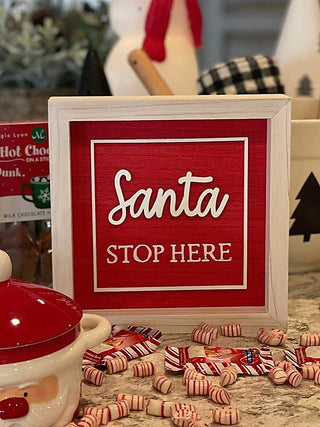 Reversible wood holiday sign with “Santa” and “STOP HERE” on a red side