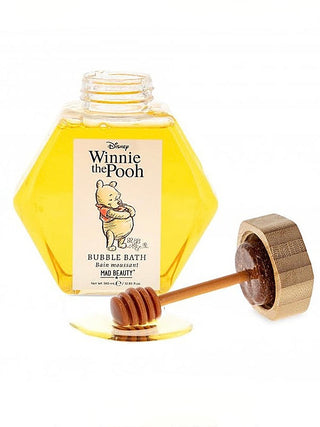 Honeycomb bubble bath bottle with Winnie the Pooh label, yellow liquid and honey dipper