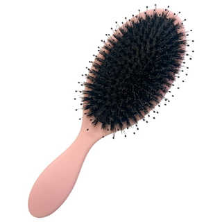 Pink hair brush with round dark bristle head and oval handle.