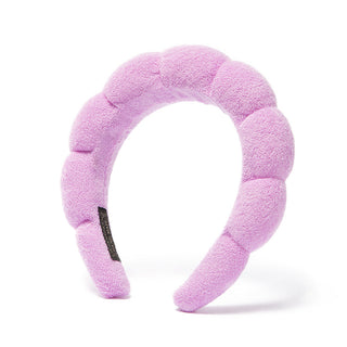Light purple plush bubble headband with scalloped pads and black logo patch.