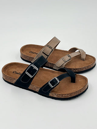 Black faux leather sandals with two adjustable buckle straps and open toe