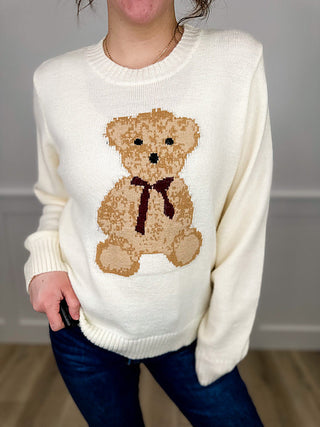 Cream knit sweater with teddy bear intarsia graphic on front, long sleeves