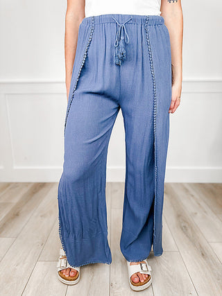 High-rise denim blue swim cover-up bottoms with tassel drawstring and wide-leg fit