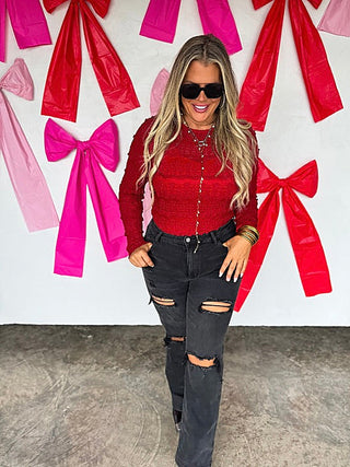 Red lace long-sleeve top with textured pattern and round neckline