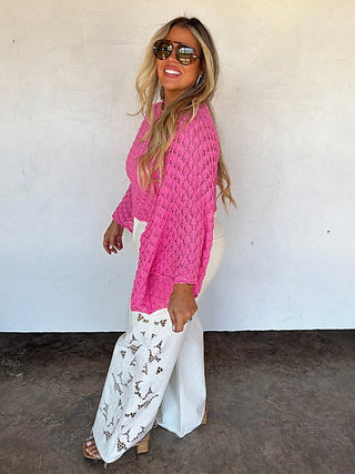 White high-rise wide-leg jeans with embroidered panels and clean hem