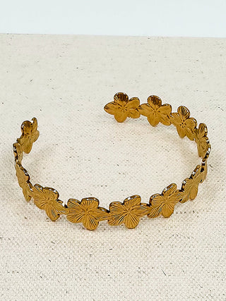 Gold floral link bracelet with textured flower details