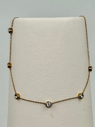 Gold chain necklace with three round crystal charms and a small adjustable clasp
