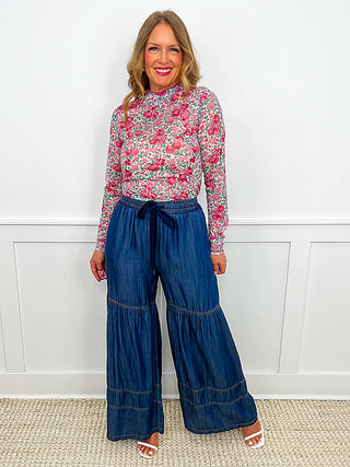 High-rise wide-leg dark wash denim pants with drawstring waist and tiered seams