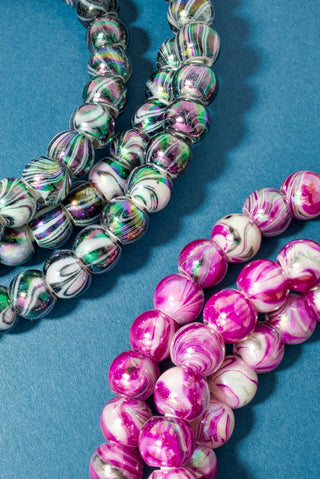 Marble pink beaded phone charger cord with coiled beads and connector ends