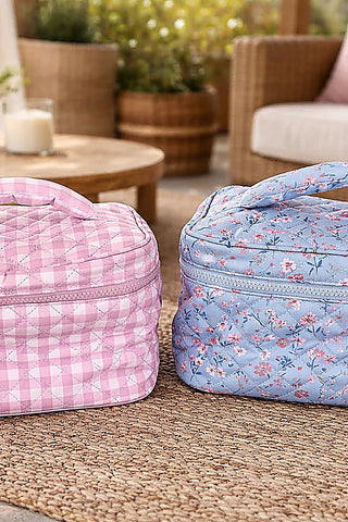 Quilted makeup bags, pink plaid and blue floral, both with zippers.