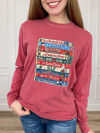 Red long-sleeve graphic T-shirt with colorful holiday text print, crew neck