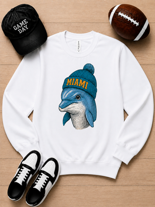 White long sleeve crewneck sweatshirt with Miami graphic dog wearing a teal beanie.