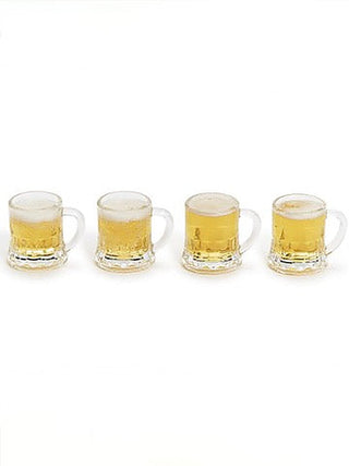 Four clear mini beer mug shot glasses with handles, filled with golden beer