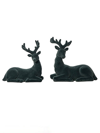 Pair of dark resin reindeer figurines, reclining side by side