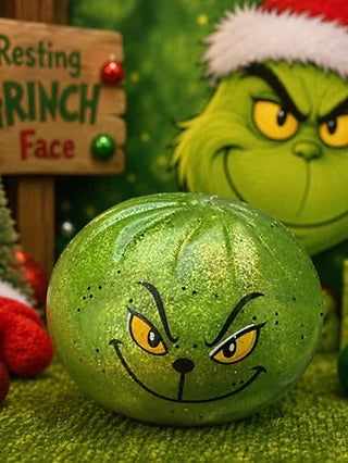 Holiday humbug dumpling squishy, green with smiling cat-like face