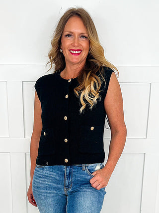 Black knit button-up sweater vest, sleeveless with front buttons.