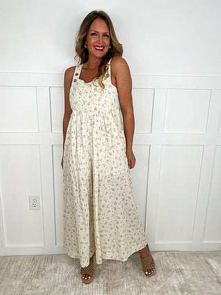 Cream cotton-blend overalls, adjustable straps, wide-leg floral print