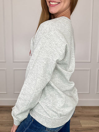 Grey crewneck sweatshirt with long sleeves, side view, no front graphic visible