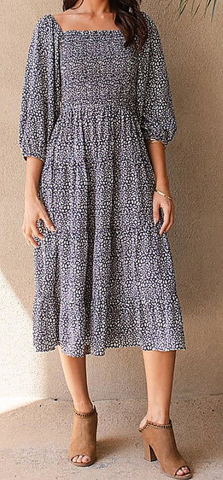 Blue patterned tiered midi dress with square neckline and three-quarter puff sleeves