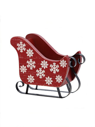Red wooden sleigh with white snowflake decals, black metal runners and curved handles