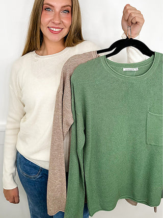 Green knit long sleeve sweater top, crew neck, ribbed cuffs, front pocket detail